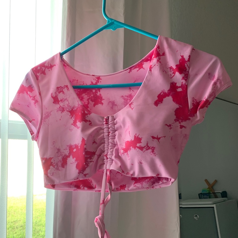A pink bathing suit crop top